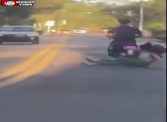 Video: During a roadrage, she tries to bring down a scooter rider, and karma intervenes